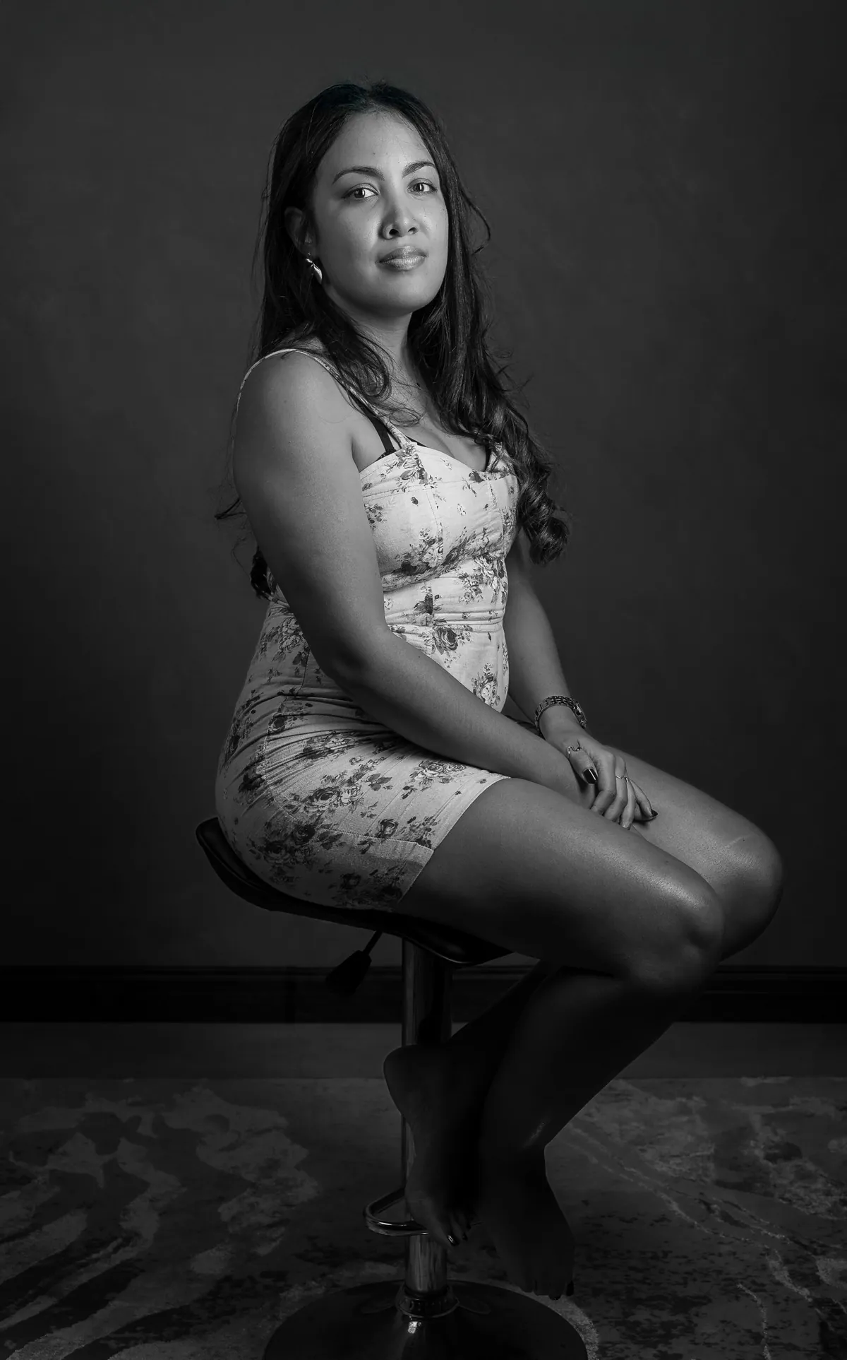 Black-and-white full-body portrait of Emilie seated in the studio
