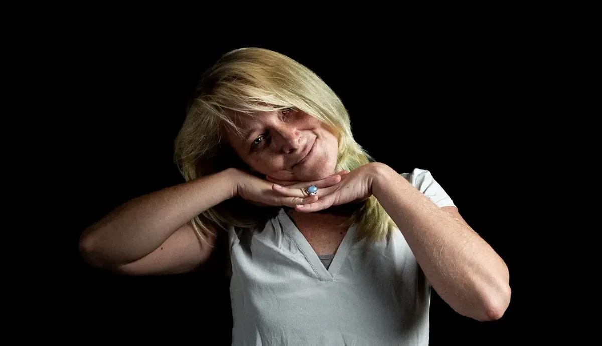 Creative studio portrait of Julie posing against a dark background