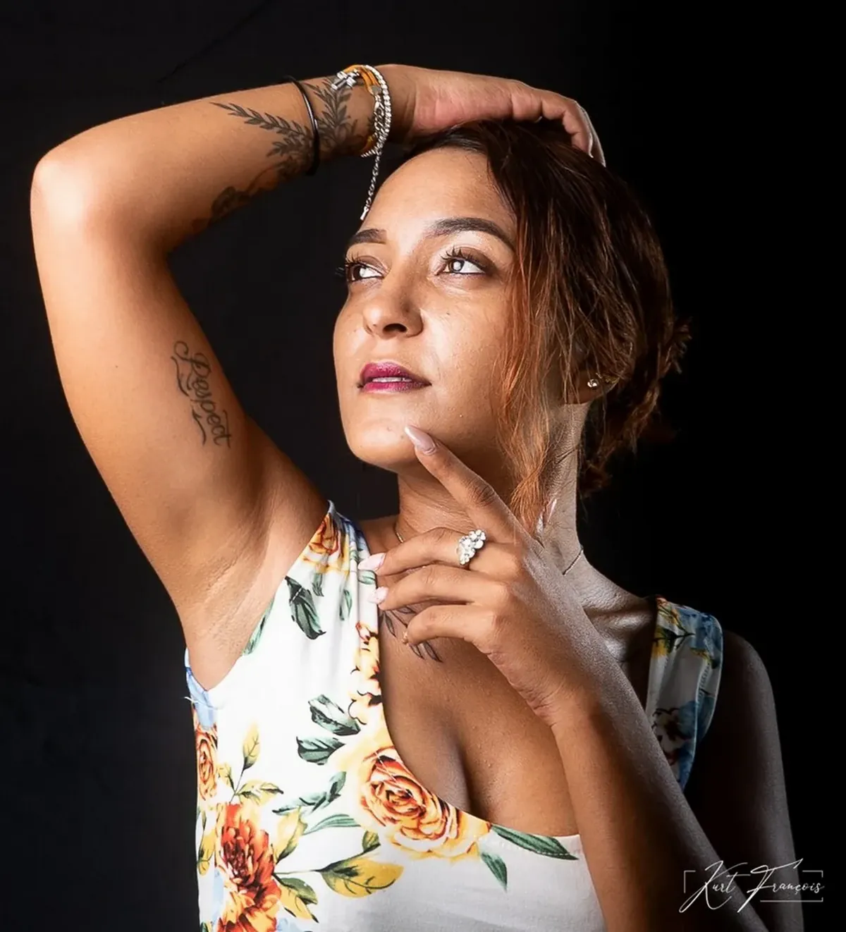 Close-up profile portrait of Laetitia François posing against a black background