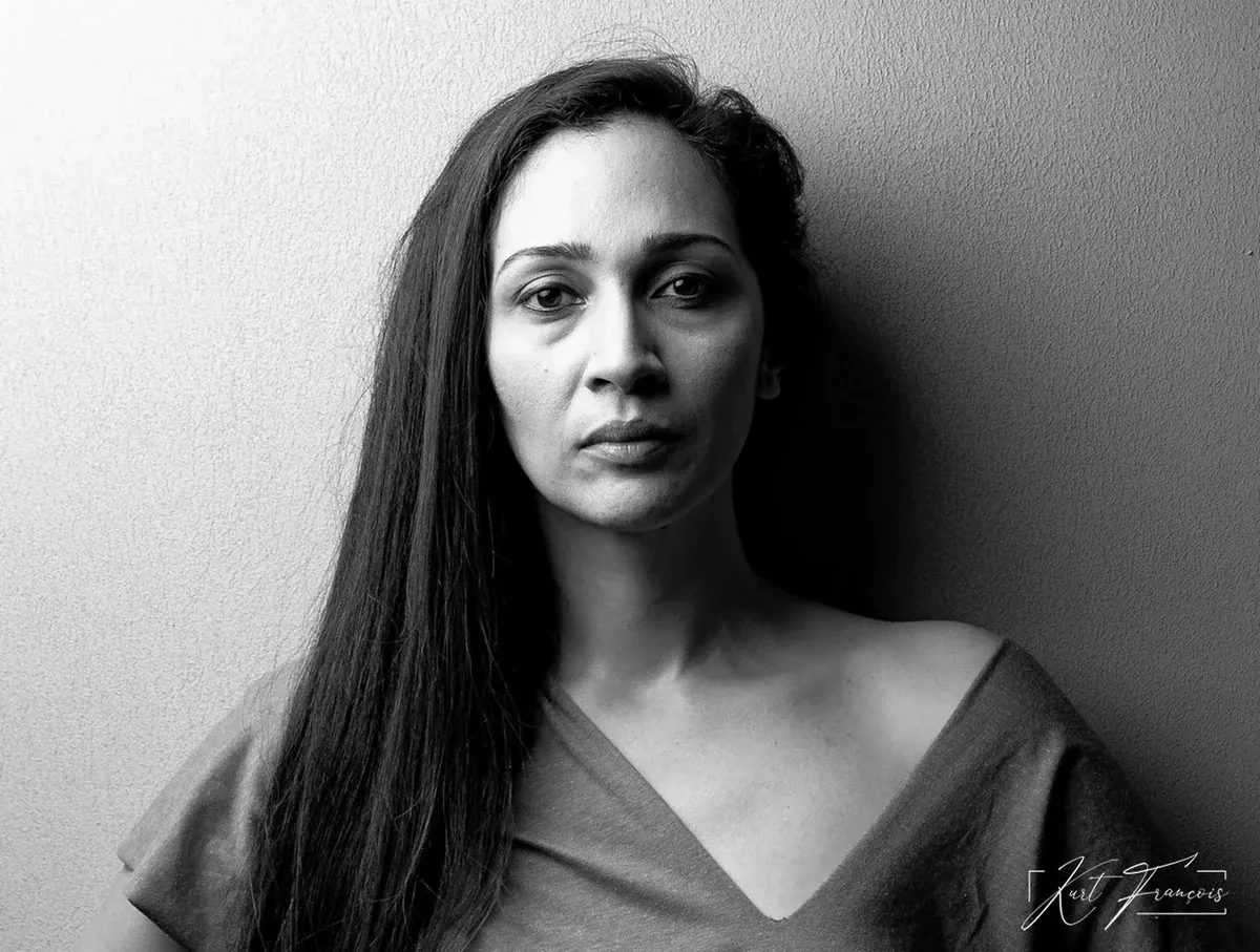 Black-and-white profile portrait of Martine photographed against a light background
