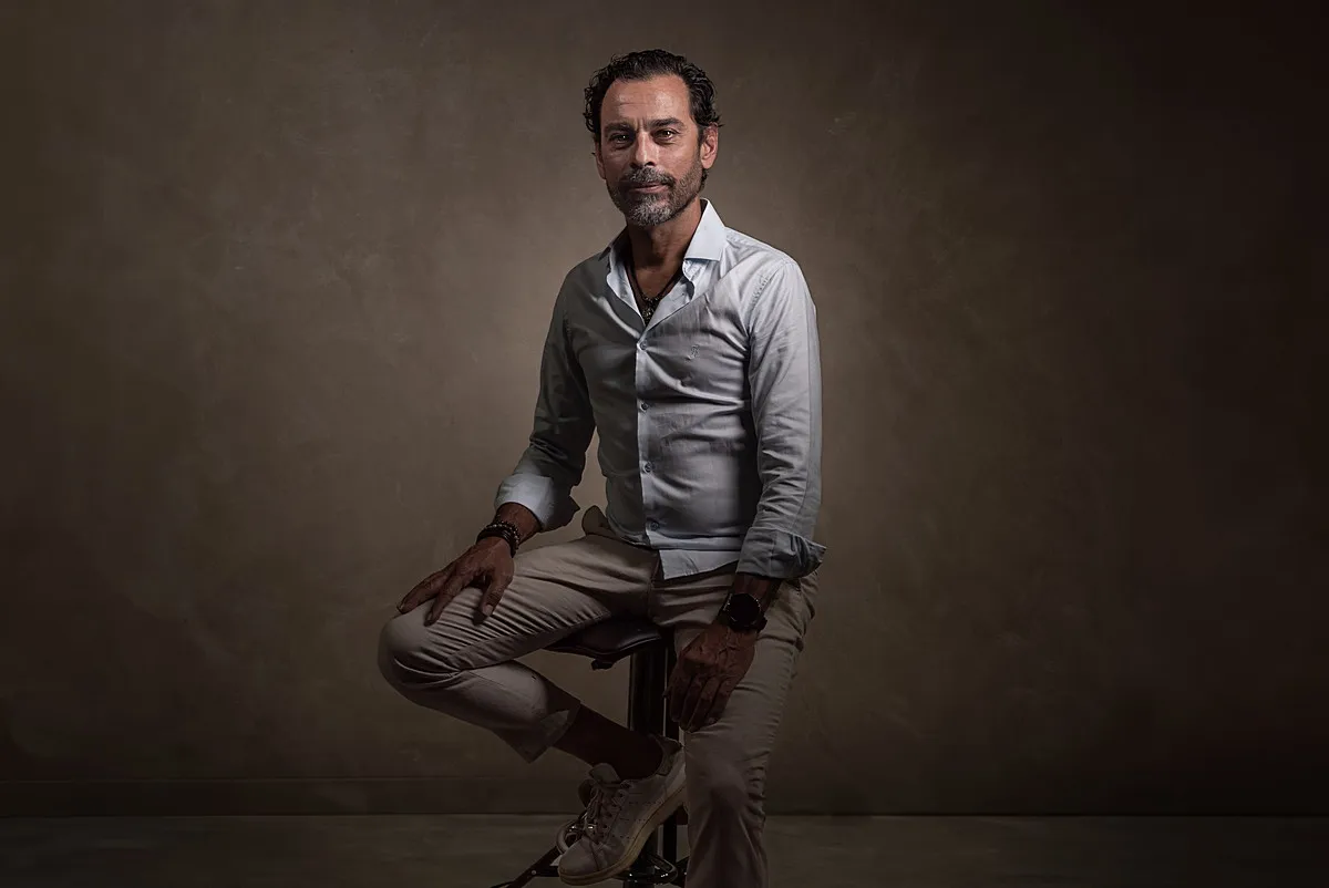 Finished portrait of a seated client photographed with controlled studio lighting