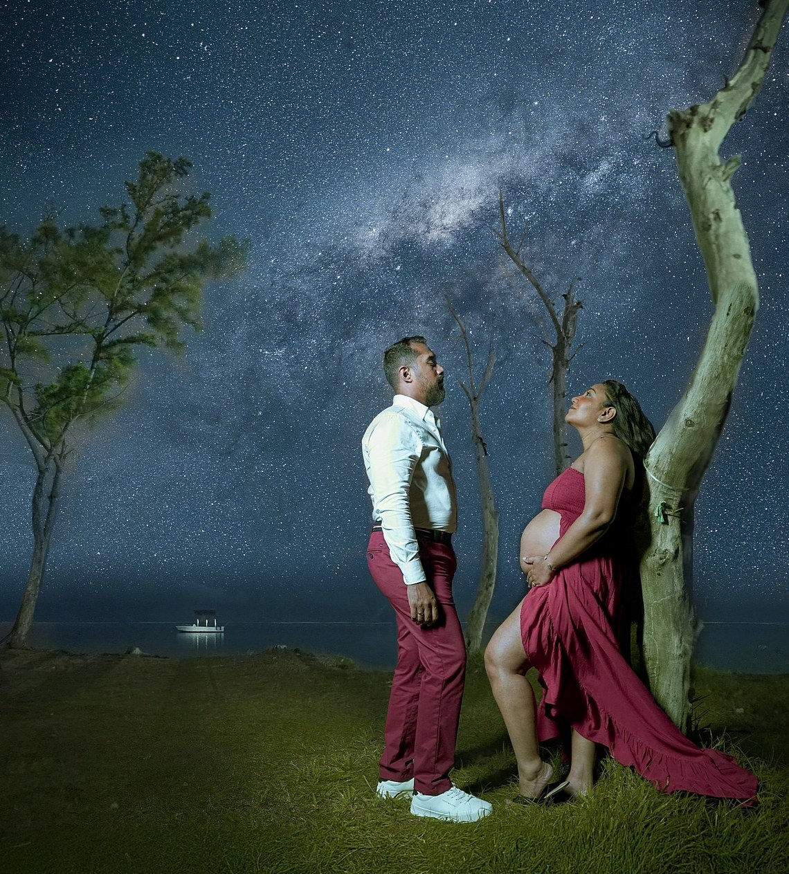 Pregnant couple posing on the beach under the Milky Way in Mauritius at night