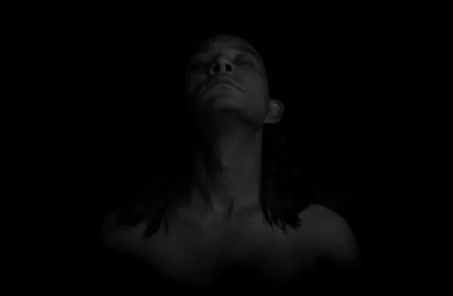 Black and white abstract male portrait with face partially hidden in shadow