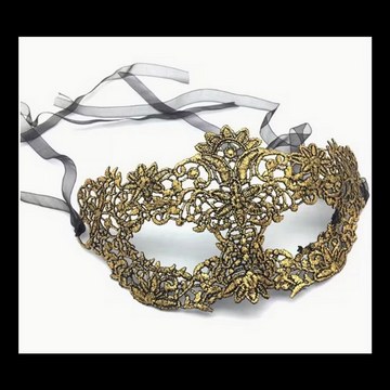 Gold lace masquerade mask with black ribbons, used as a studio photoshoot accessory.
