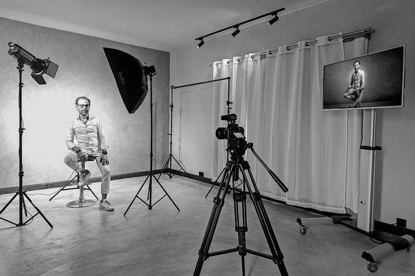 Full studio setup at Boudoir Studio showing lights, camera, and TV display during an indoor shoot